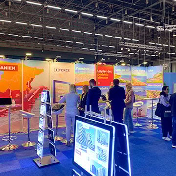 exhibition area with presenter helping people at stand