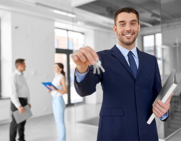 Smiling Realtor With Keys Folder New Office Smiling Realtor With Keys Folder New Office