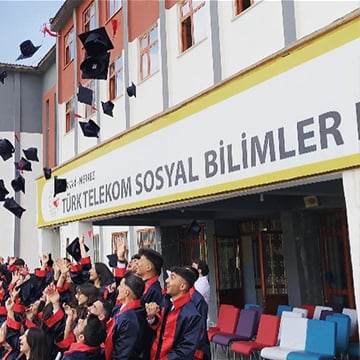 students throwing caps to air front of a school students throwing caps to air front of a school