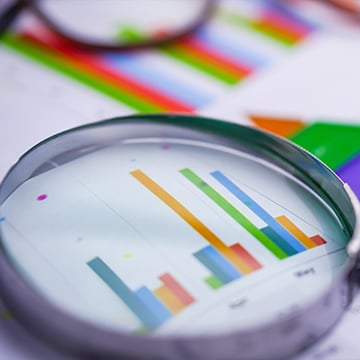 Photo magnifying glass on charts paper Photo magnifying glass on charts paper