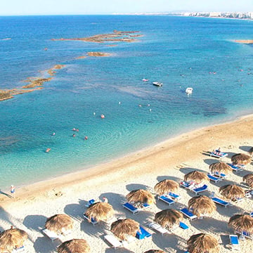 sun beds and umbrellas at beach with beautiful sea view