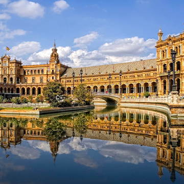 historic place with reflection in water in seville