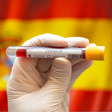 A hand holding covid test tube