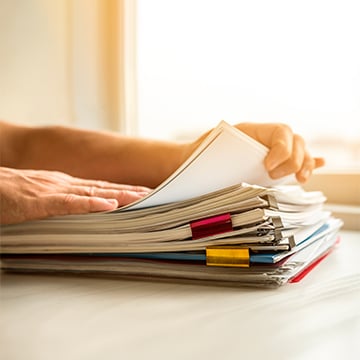 Middle-aged man looking through documents Middle-aged man looking through documents
