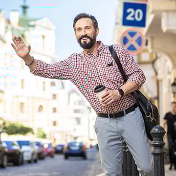 middle-aged man waving for a cab on street middle-aged man waving for a cab on street